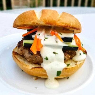 asian chicken burger on a white plate