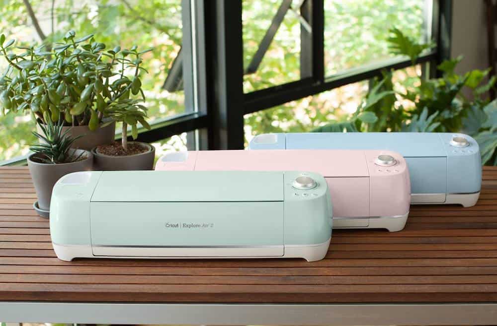 3 cricut explore air 2 machines in blue green and pink