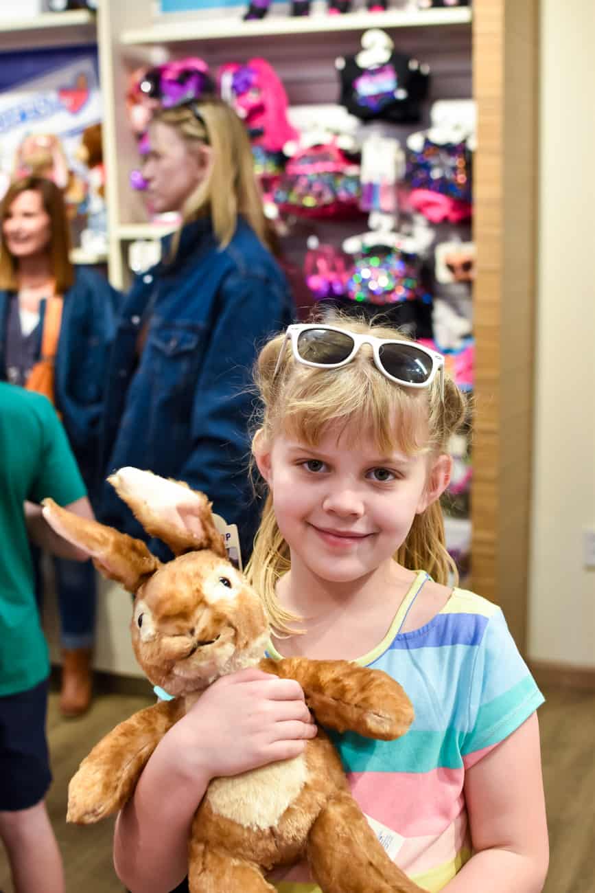 Girl holding Peter Rabbit at Build a Bear workshop