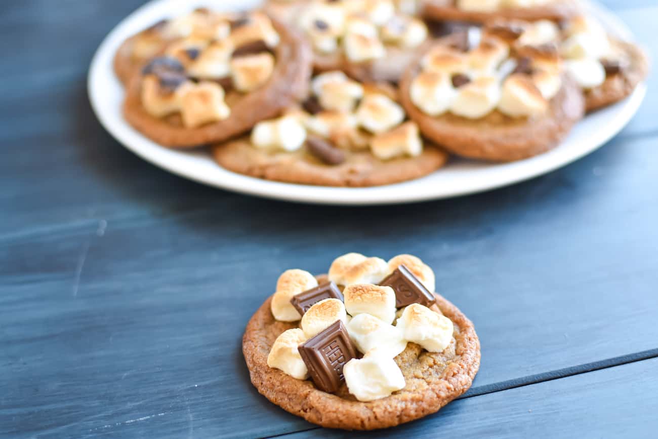 1 brown butter panbanging cookie in front of a plate of cookies