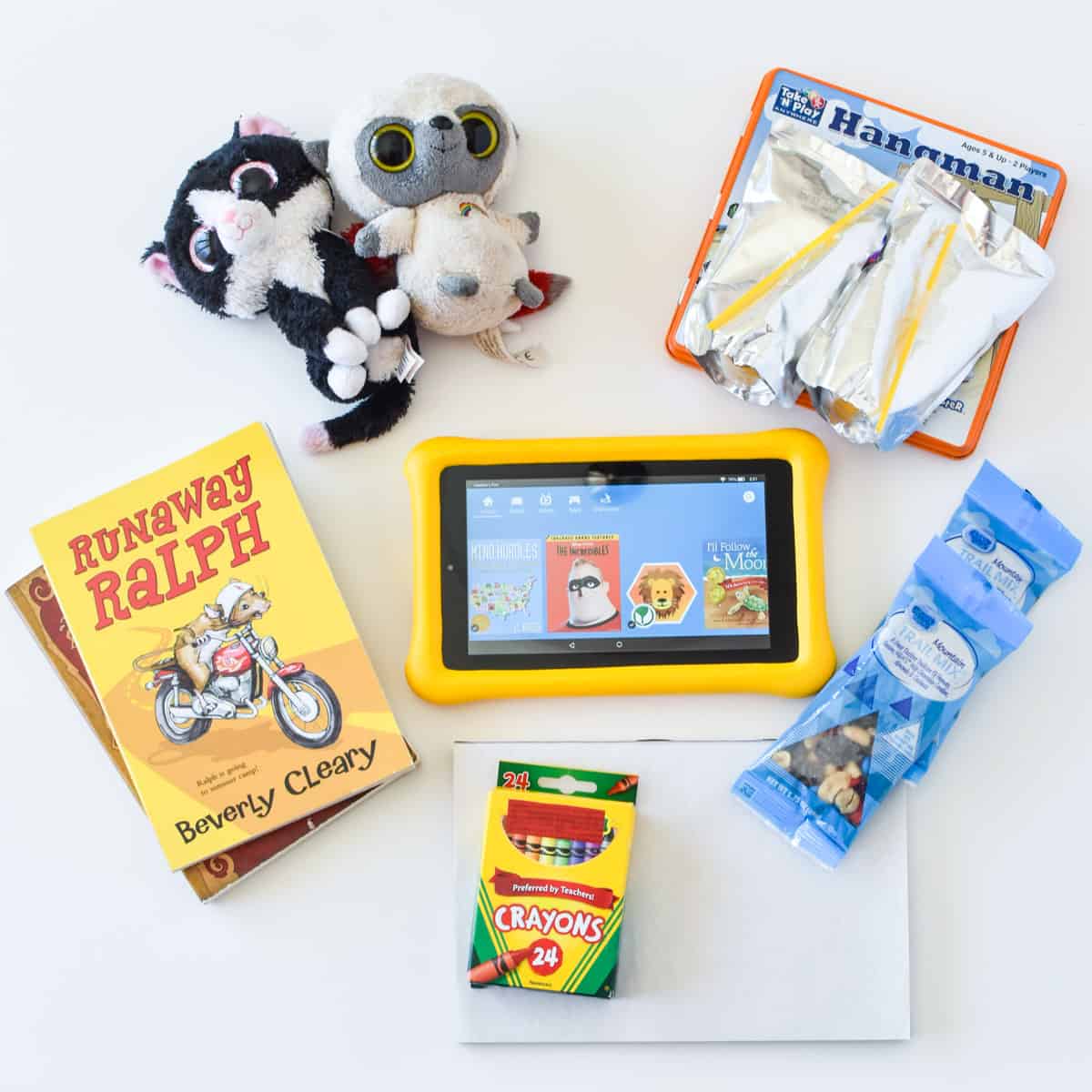 books stuffed animals, tablet, crayons and other road trip essentials for kids