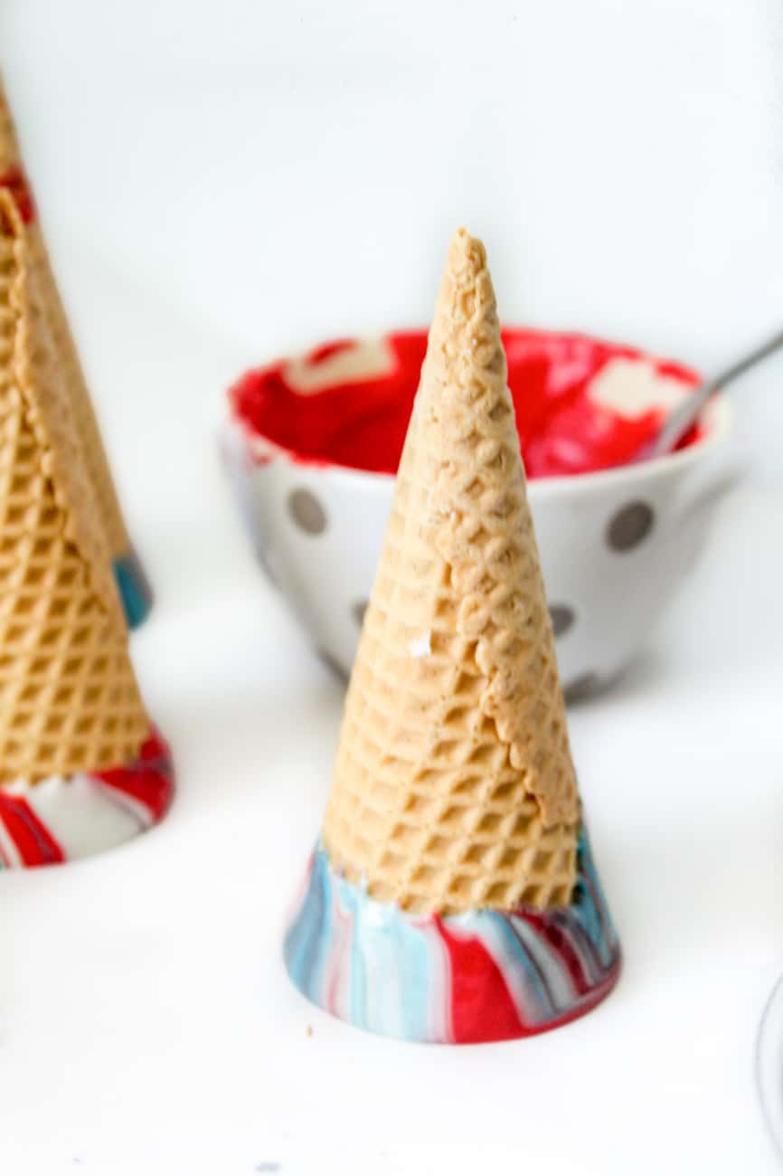 dipped sugar cones in melted rainbow candy