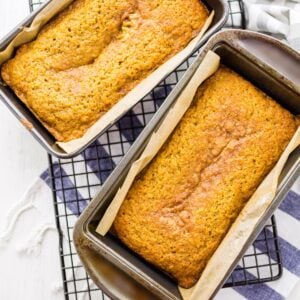 easy pumpkin bread with cake mix on a wire rack and a striped towel