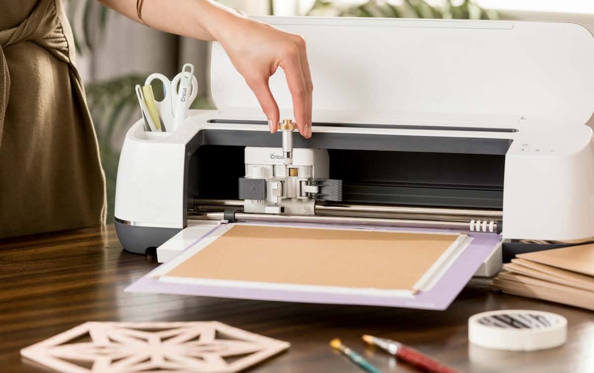 hand inserting blade into a cutting machine