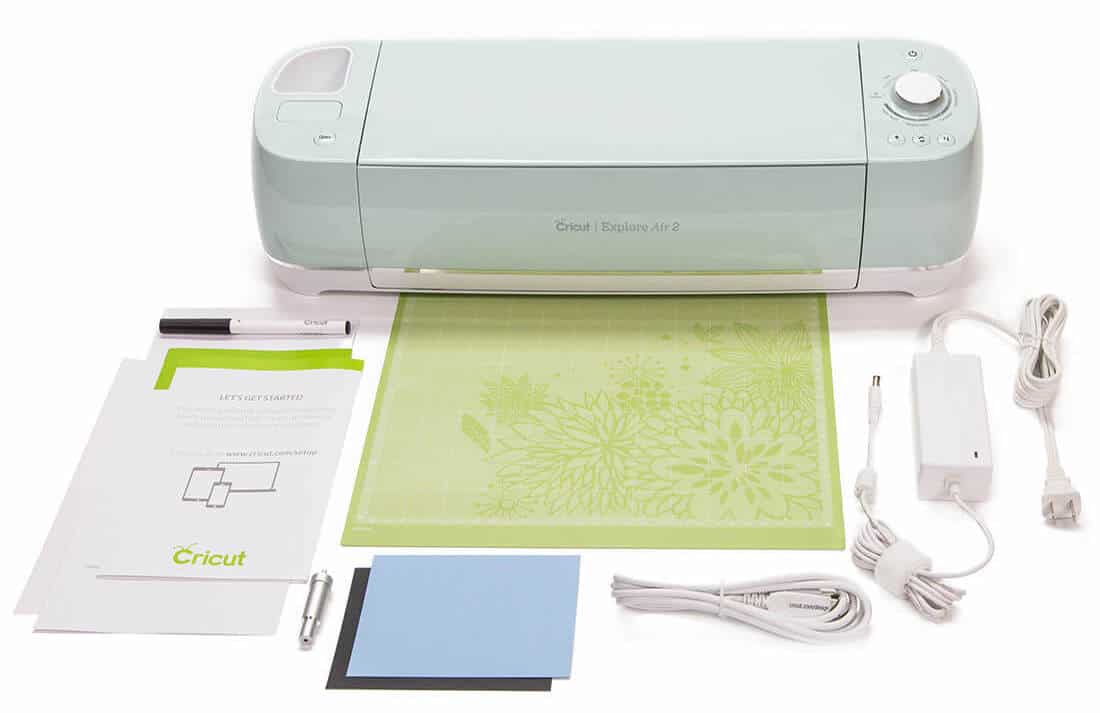 Mint green Cricut Explore Air 2, cutting mat, instructions, cords and all items that come with it