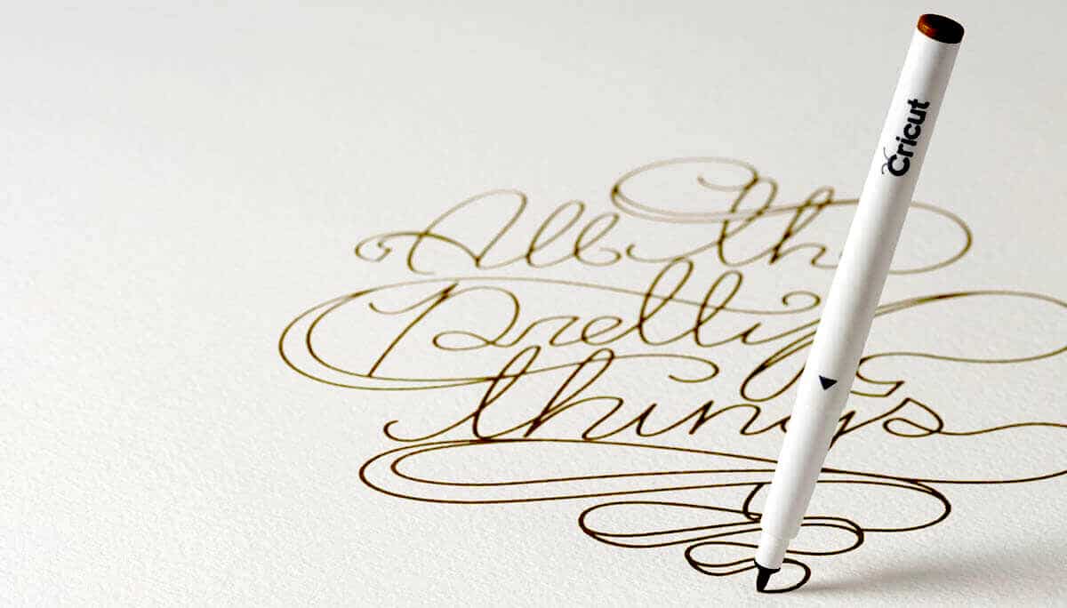 Pen writing pretty script in gold ink