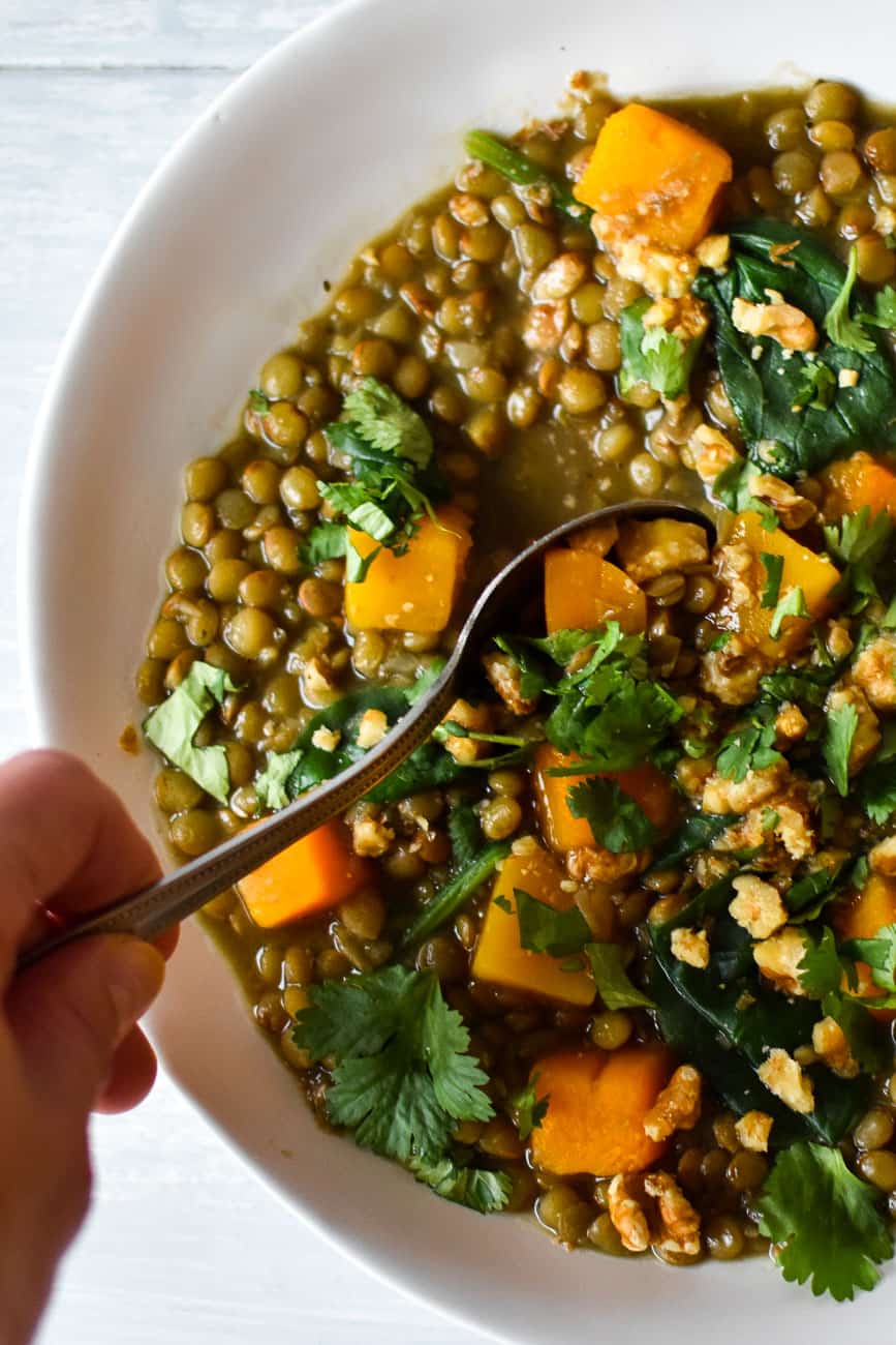 spoon in vegan lentil soup