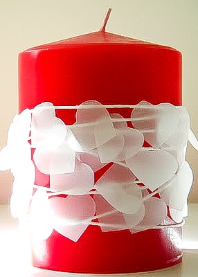 red candle with heart garland
