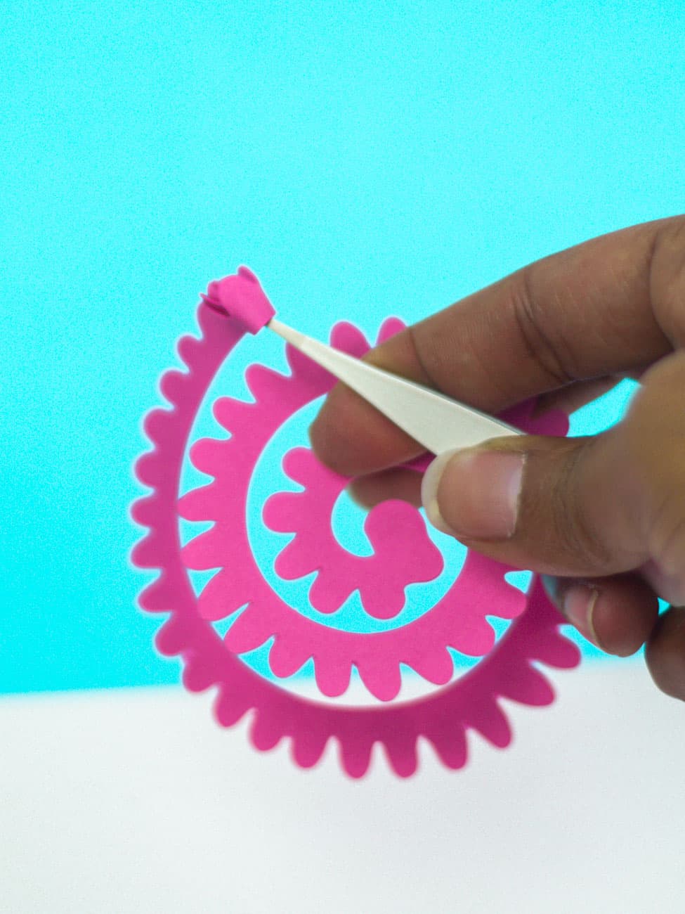 rolling cricut paper flower with tweezers