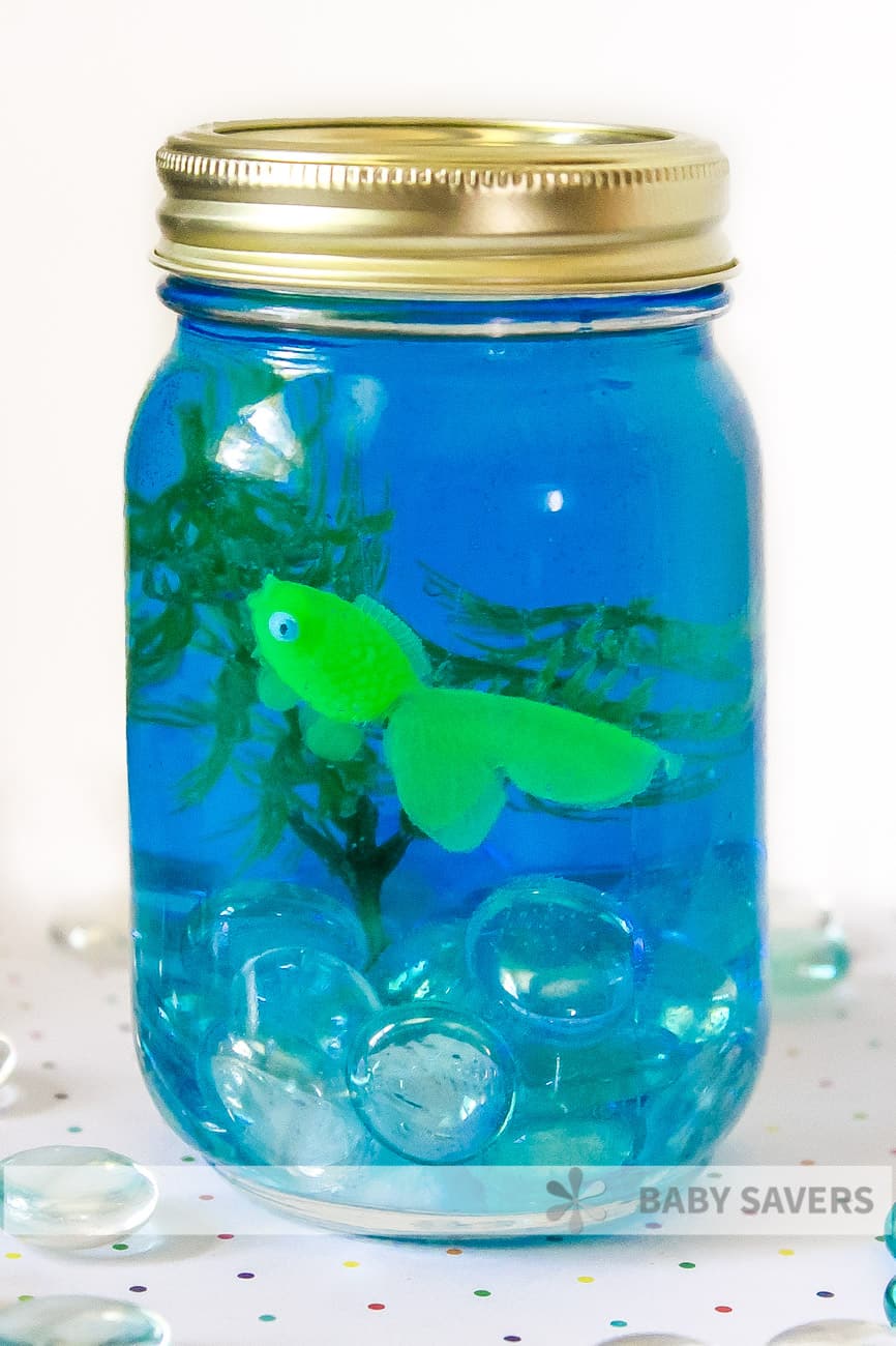 green fish in mason jar aquarium