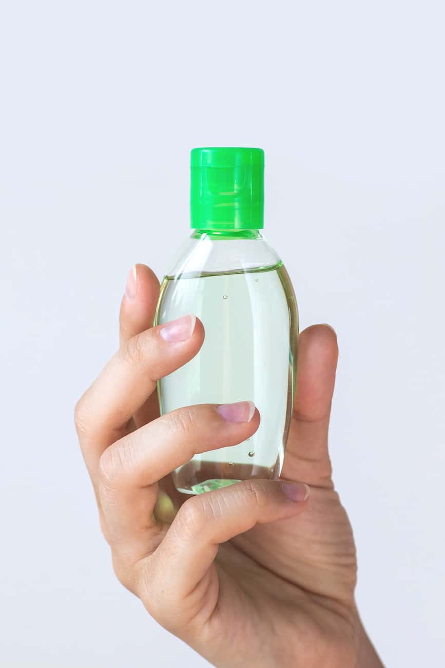 homemade hand sanitizer in green bottle