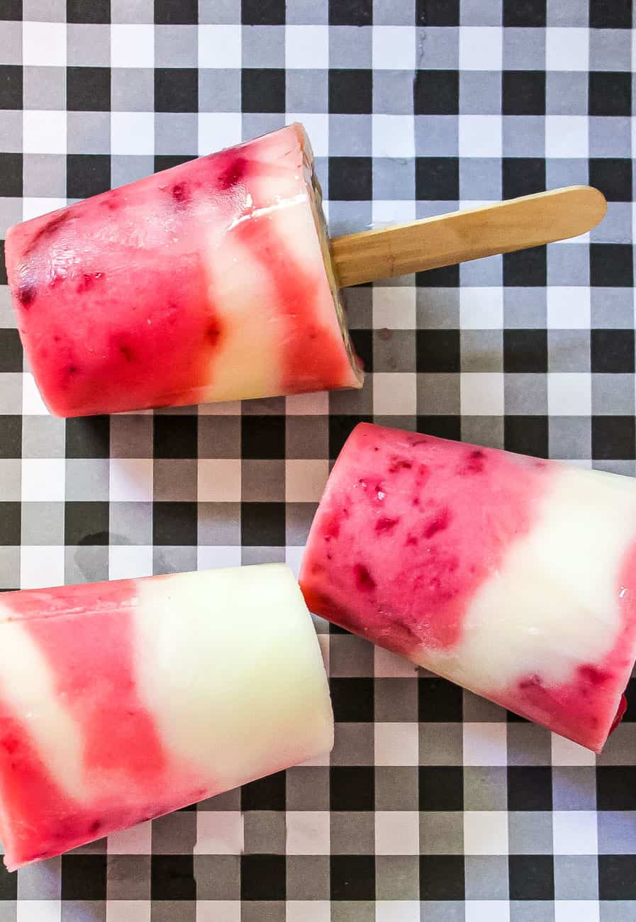 lemonade strawberry popsicles on black and white tablecloth