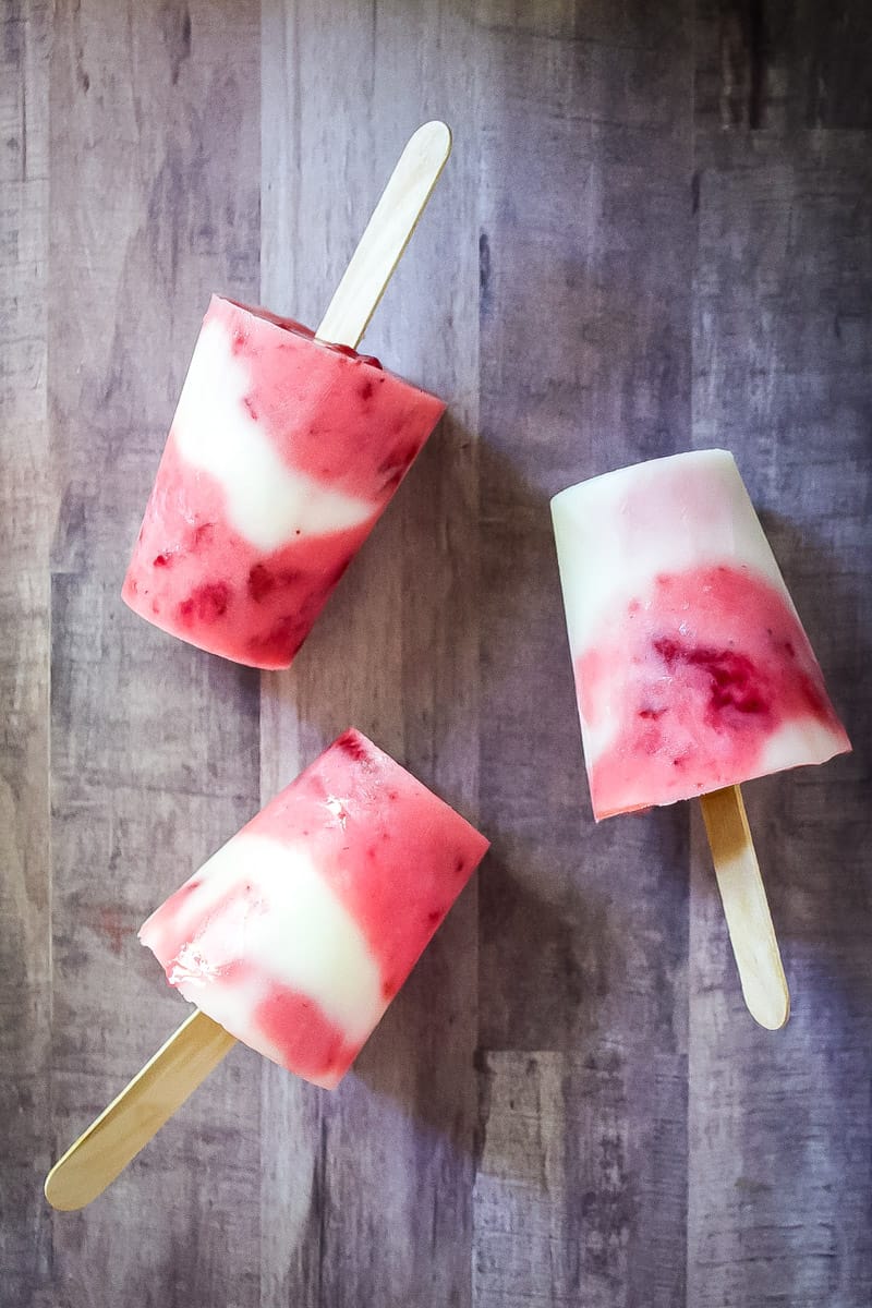 lemonade strawberry popsicles on wood background