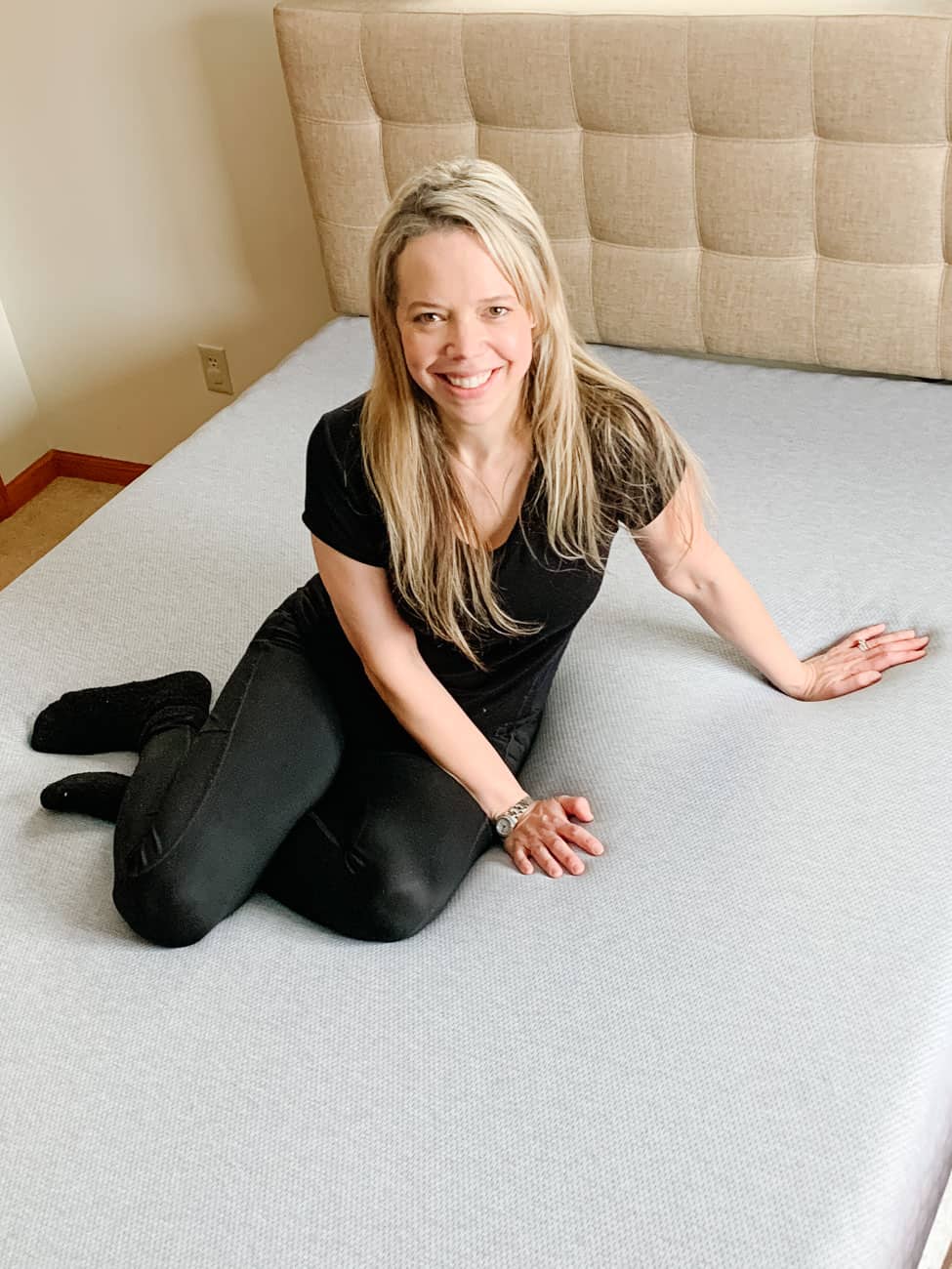 Sitting on a grey covered sports mattress
