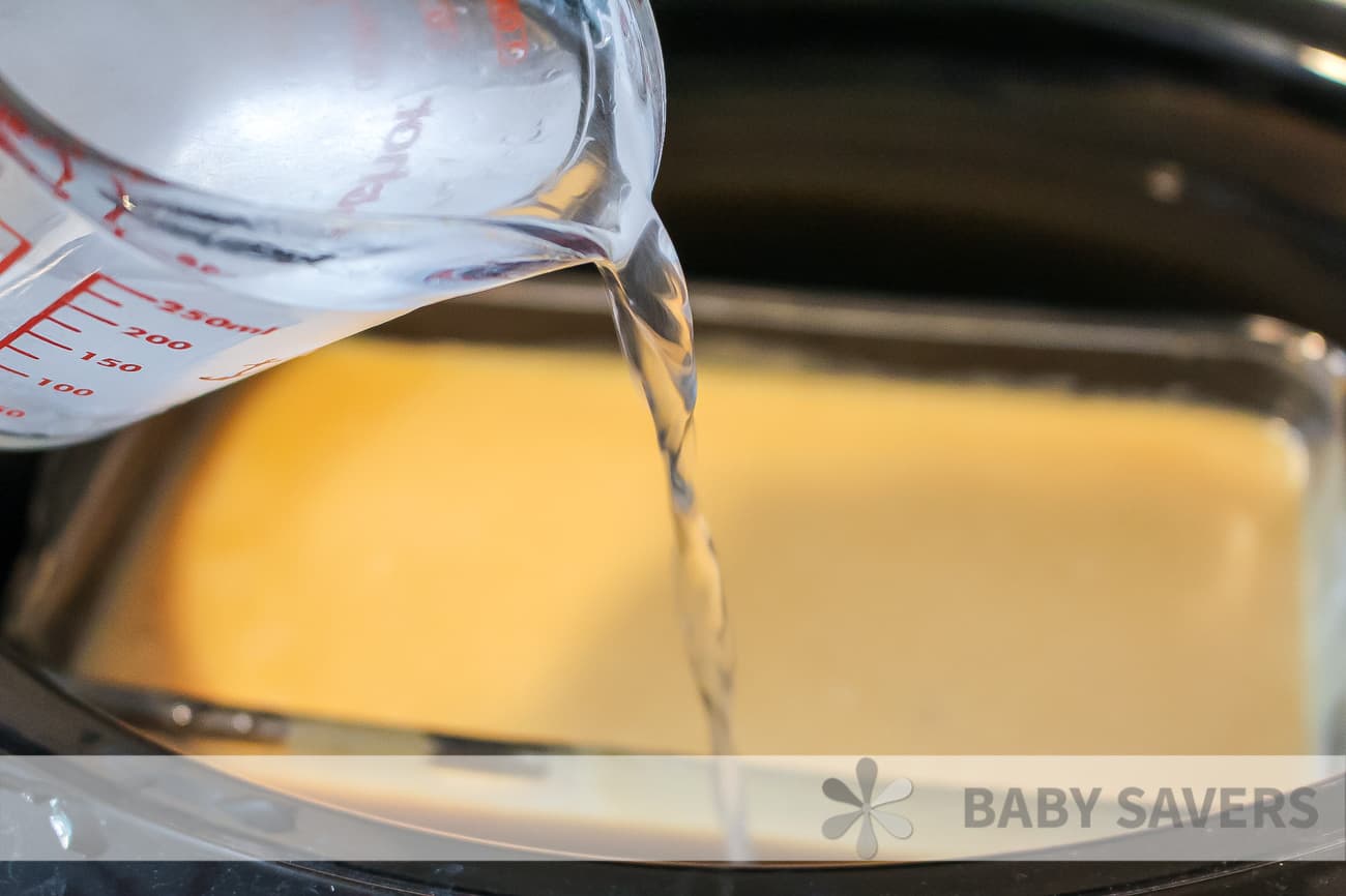 pouring water into dish inside a crockpot