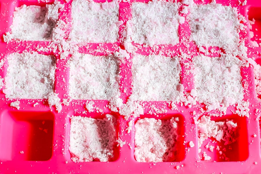 moist laundry detergent pressed into a pink square silicone mold