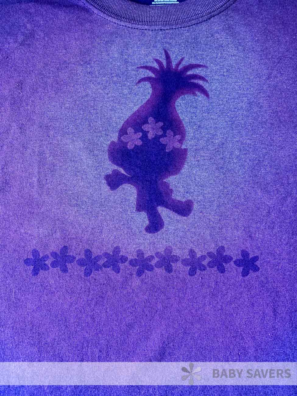 Bleach dye pattern of troll on a purple, mottled shirt
