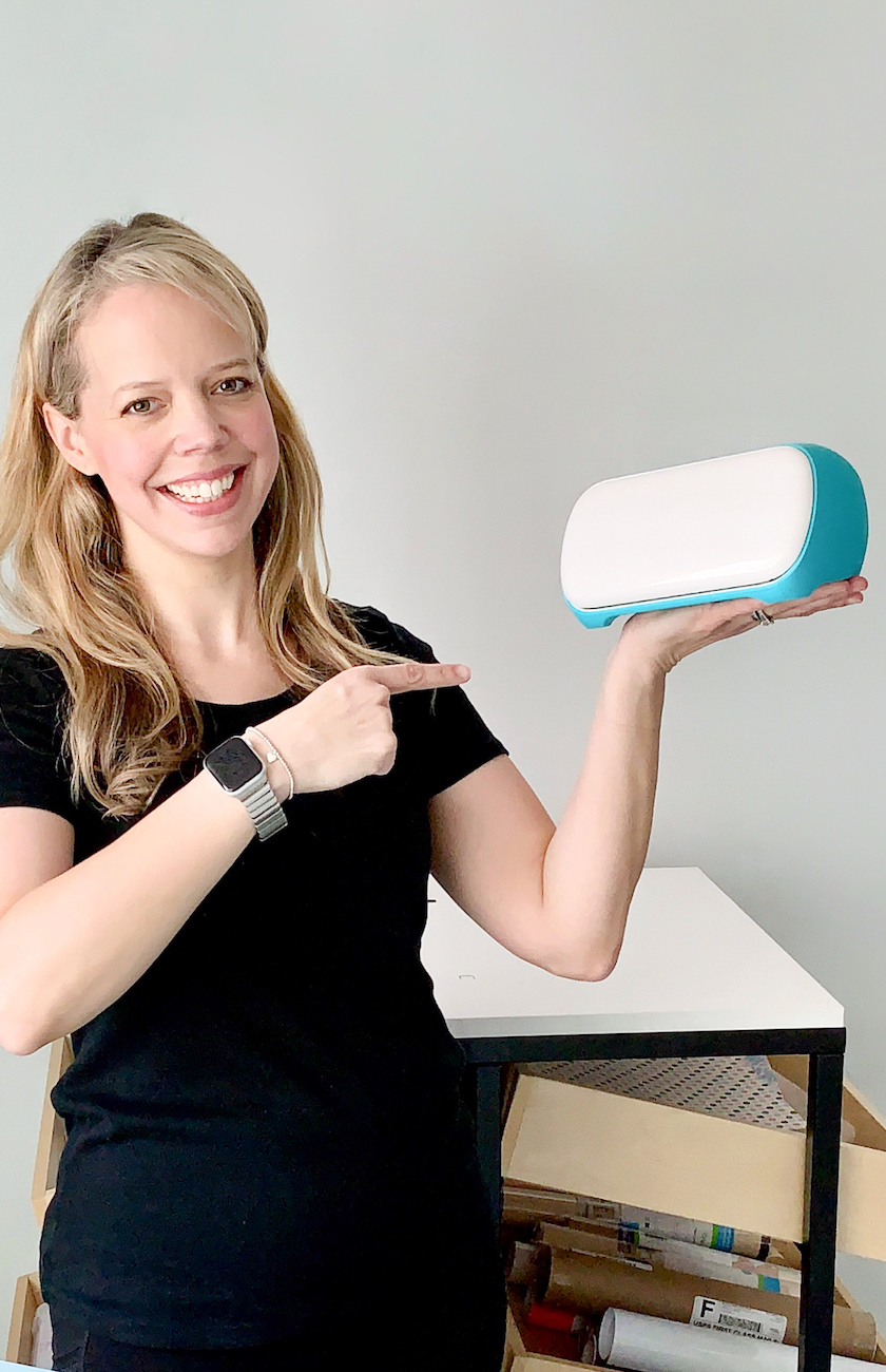 smiling woman holding a Cricut joy machine