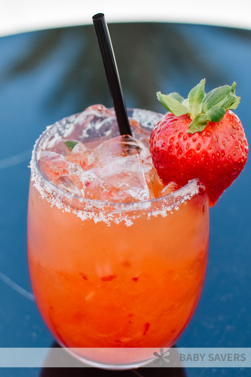 red strawberry basil margarita with salt on the rim and ice