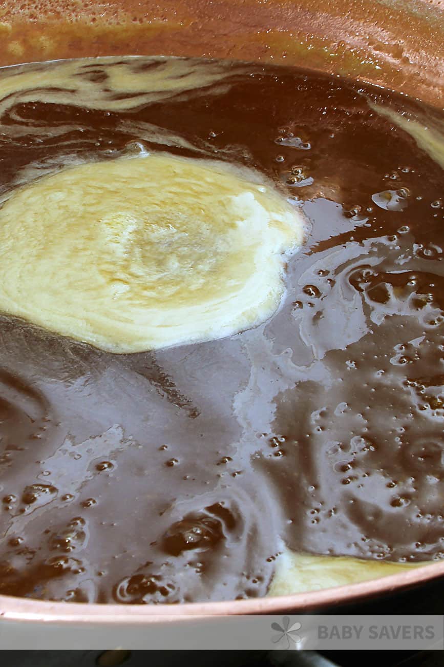 Melting butter and brown sugar in a copper pan for oyster cracker snack mix