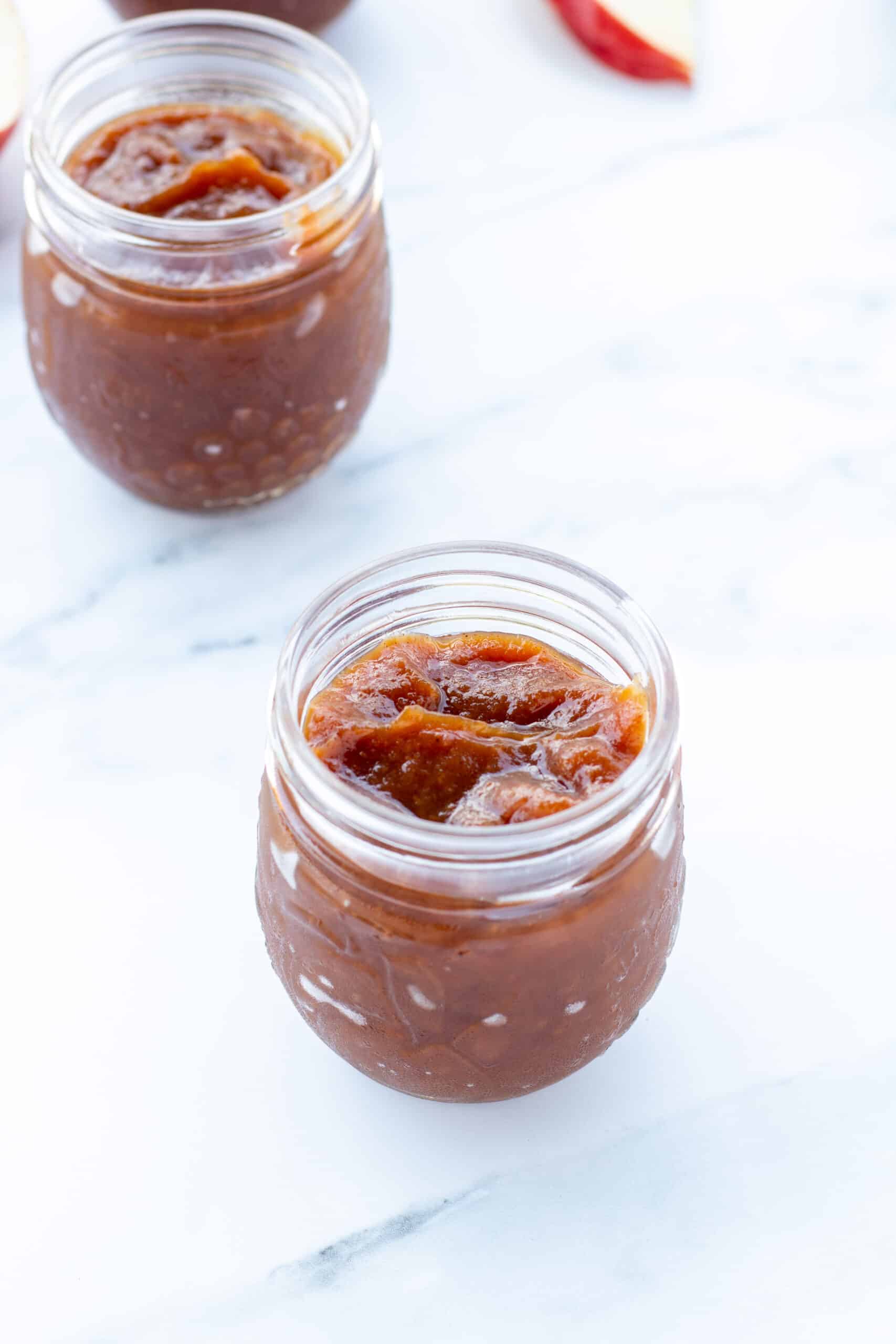 two clear jars sitting on a white counter