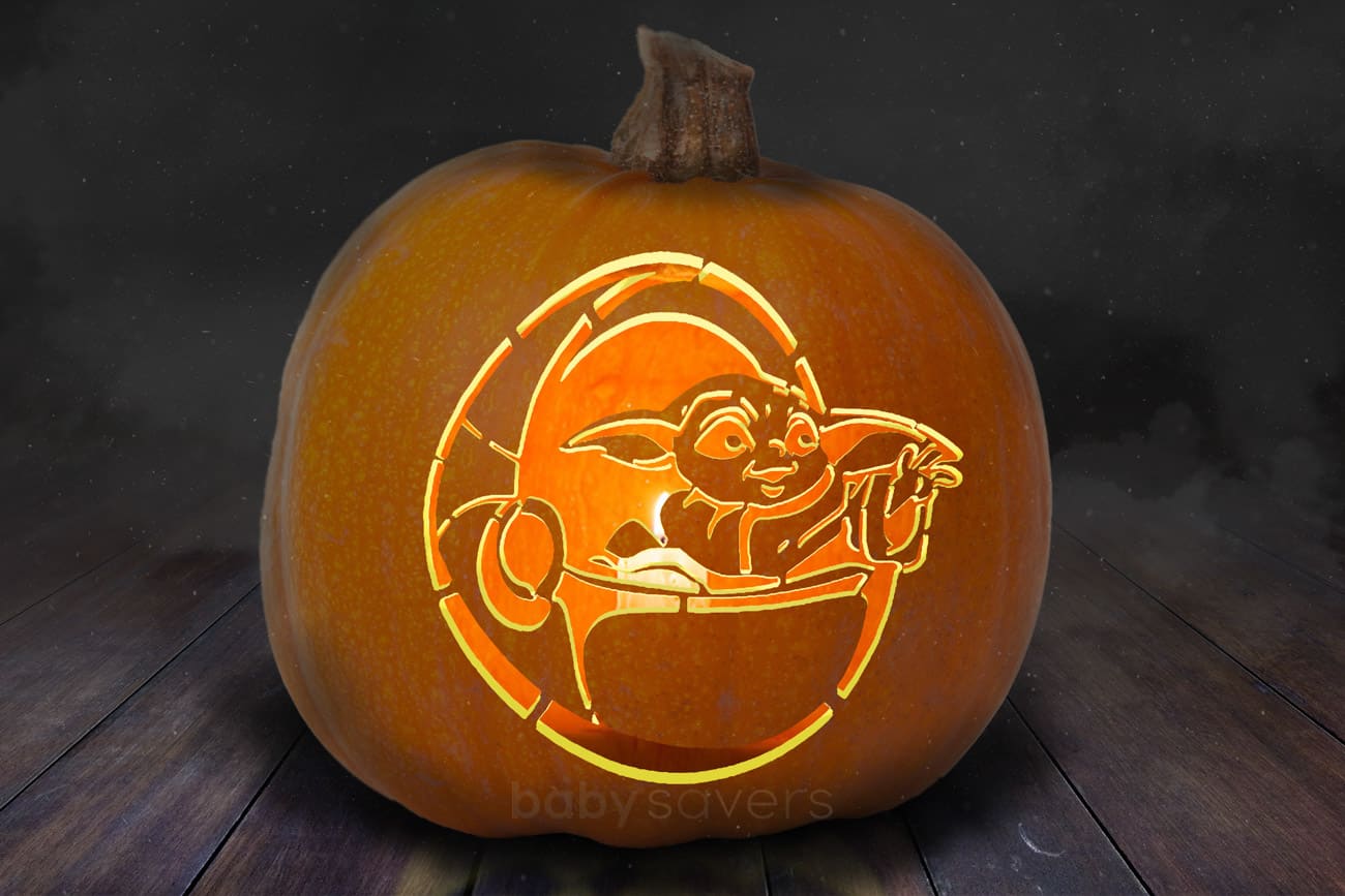pumpkin carved with Baby Yoda stencil