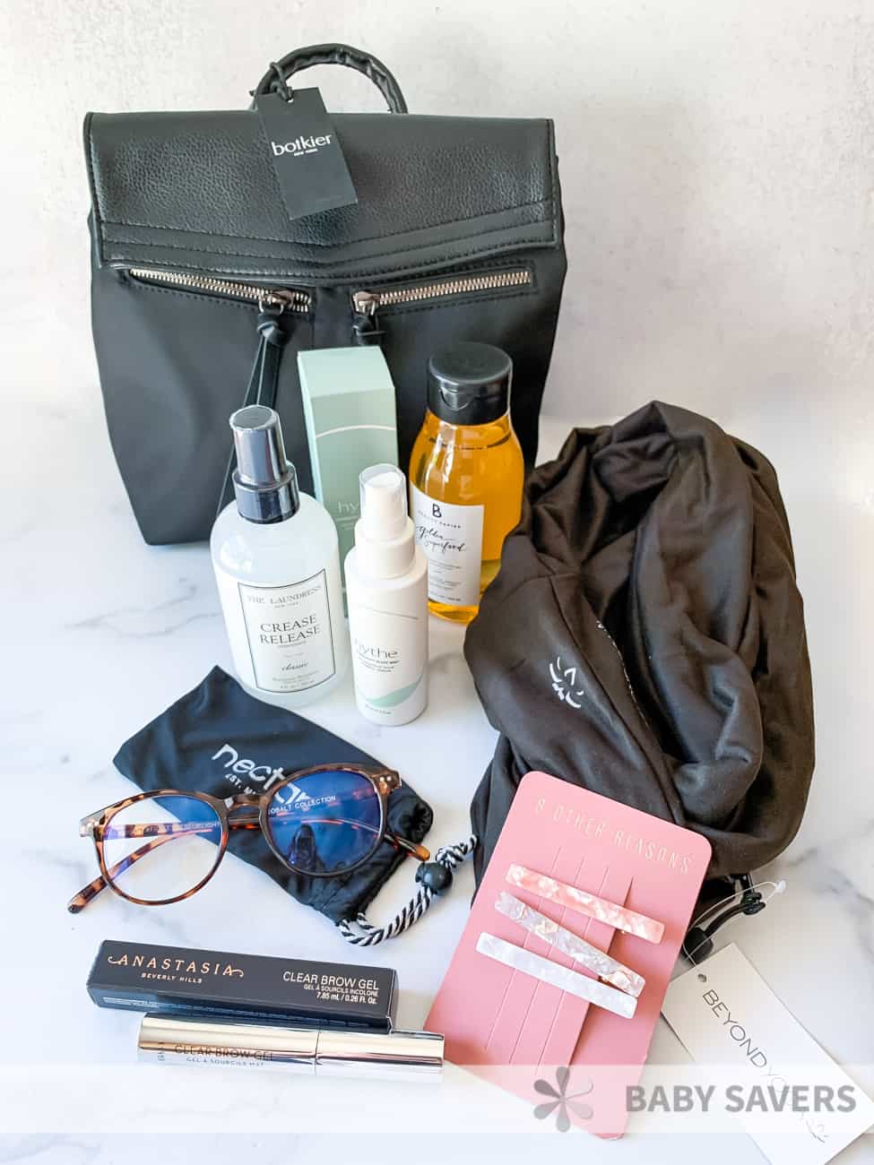 Black purse, brown scare and various products received from FabFitFun in Fall of 2020