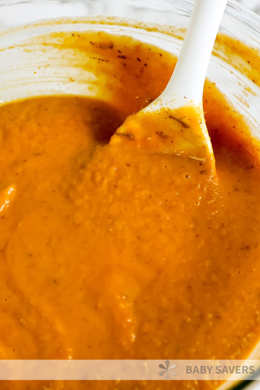 pumpkin puree in a bowl with a white spoon