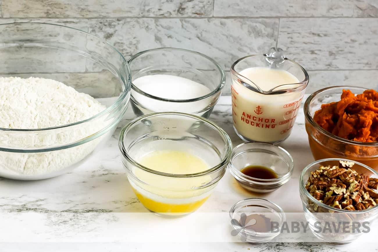 Ingredients for pumpkin crisp recipe. Cake mix, sugar, butter, evaporated milk, pumpkin puree, vanilla, cinnamon, pecans