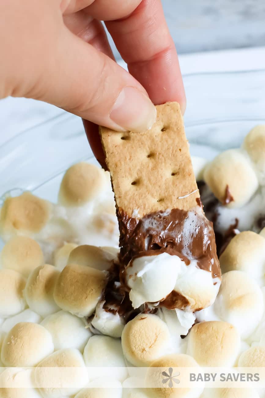 S'mores dip with toasted marshmallows on a graham cracker