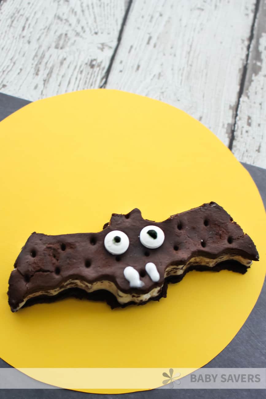 ice cream sandwich cut into the shape of a bat and decorated for an easy Halloween dessert