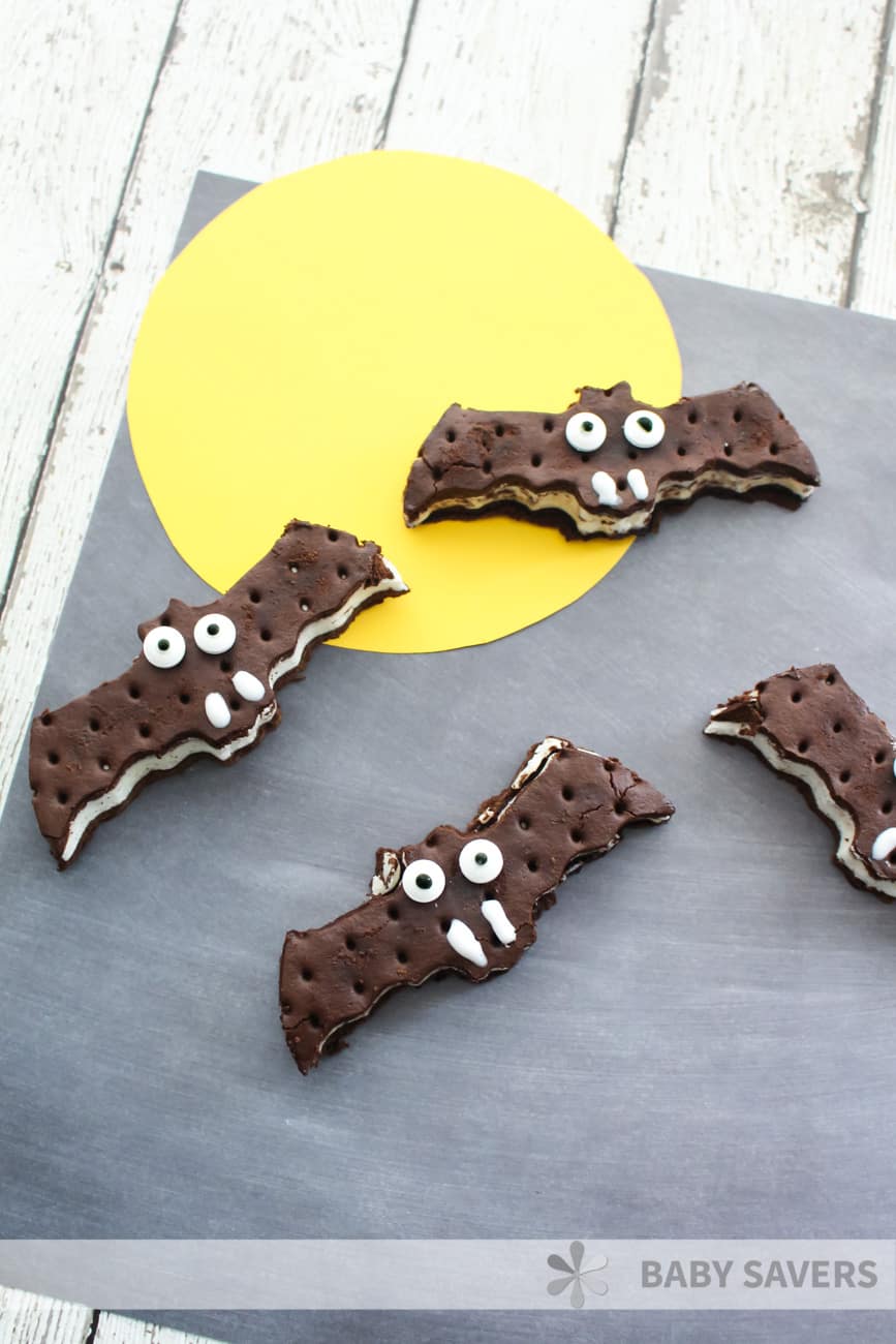 Easy halloween dessert - ice cream sandwiches cut into bat shapes and decorated with white icing