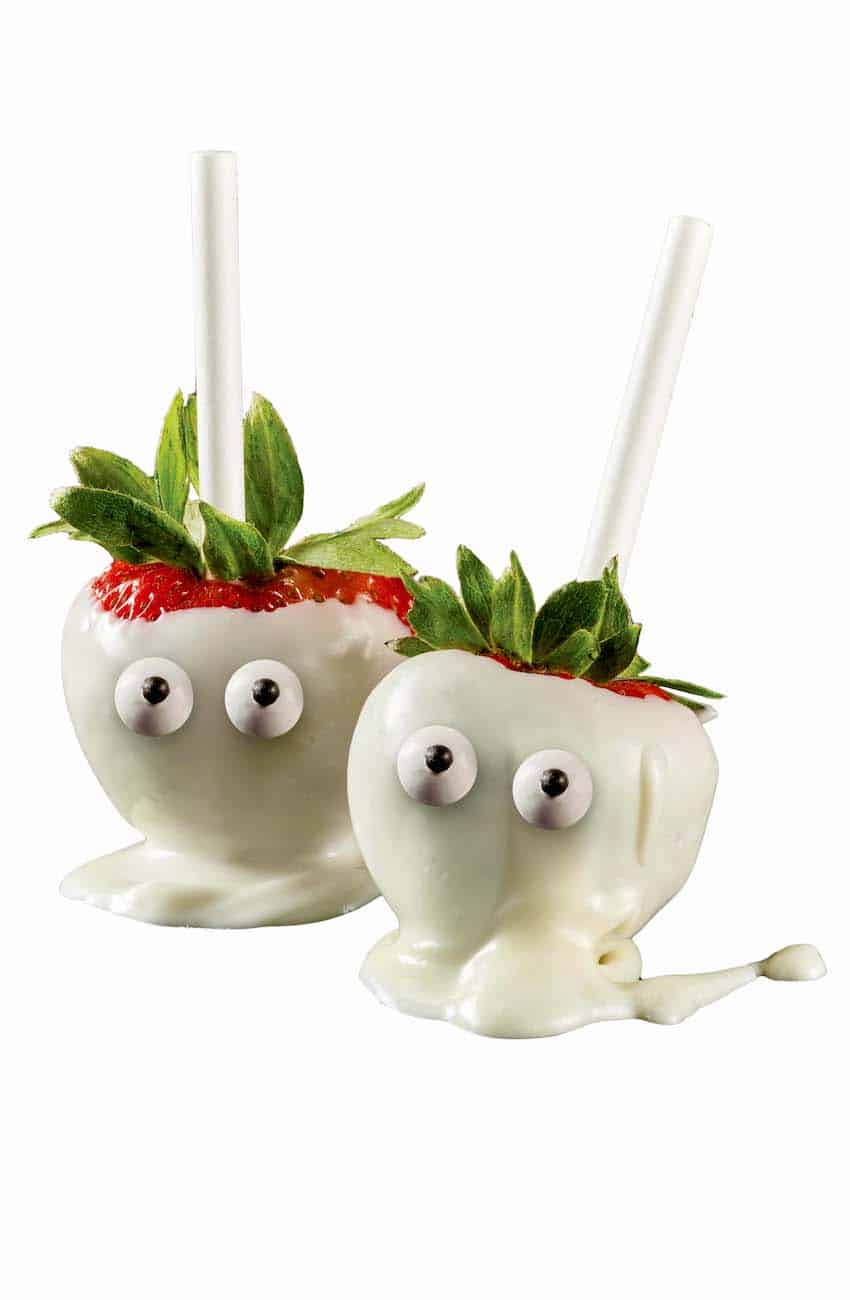 Cute halloween treat - strawberry ghosts. Fresh strawberries dipped in white chocolate with candy eyes