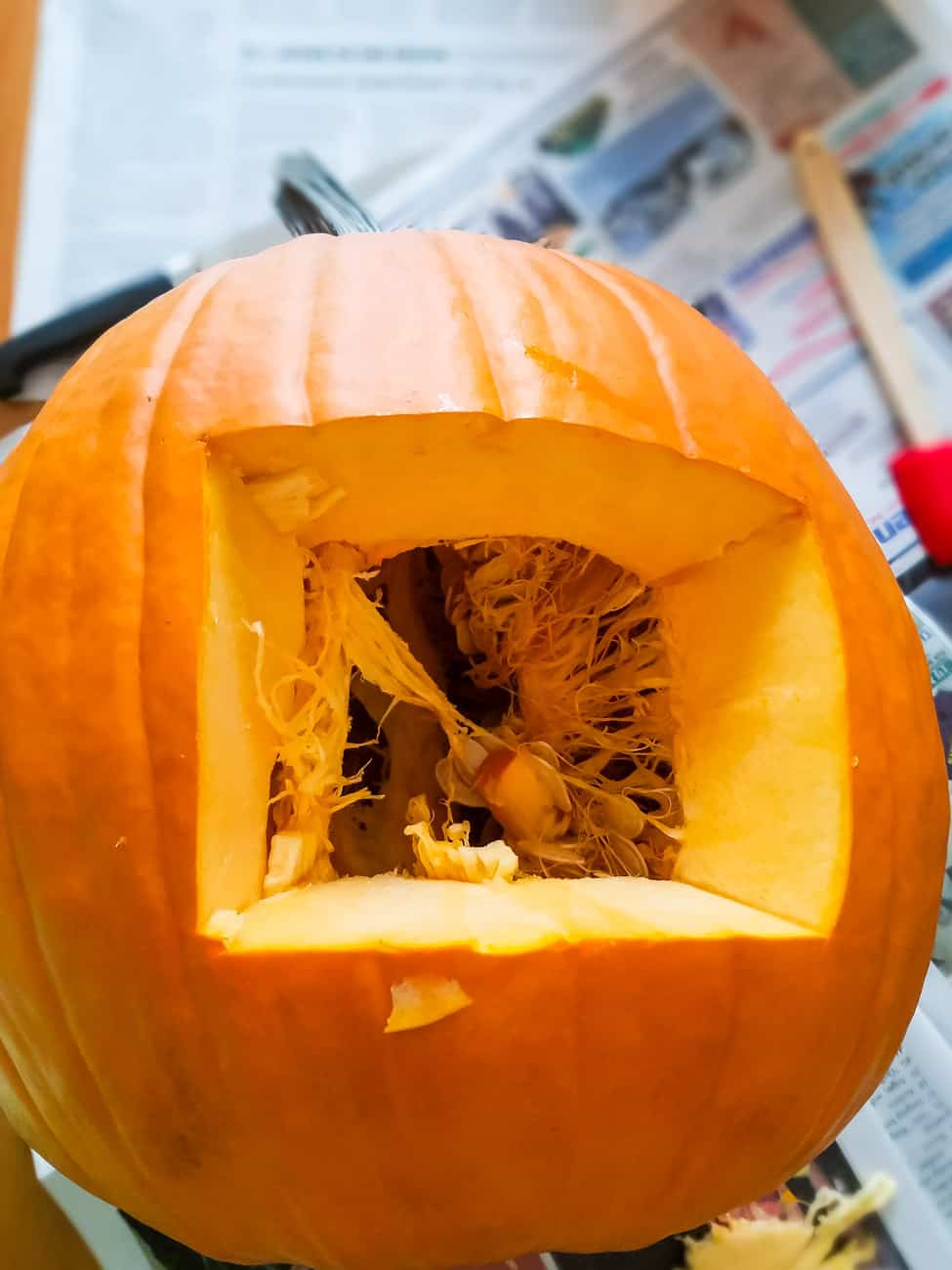square hole cut in pumpkin back to clean it out