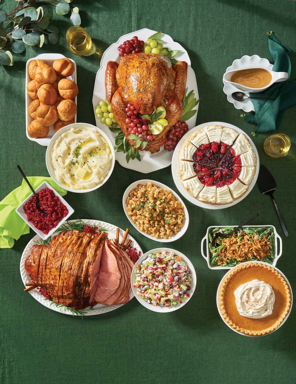 Thanksgiving turkey dinner with dessert on a green background