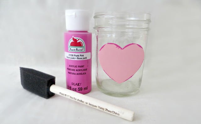 heart sticker on mason jar with acrylic paint and sponge paint brush