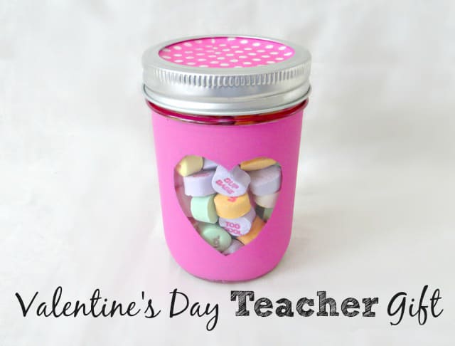 Teacher valentine gift idea: mason jar painted in pink with a heart and filled with candy conversation hearts