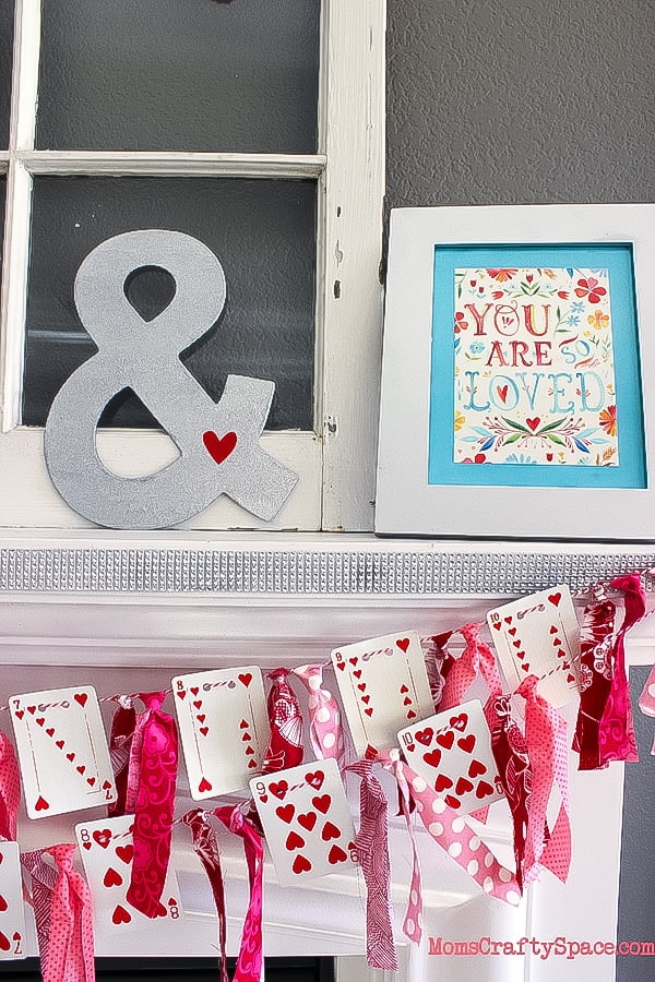 Decorated mantle with ribbon and playing card garland