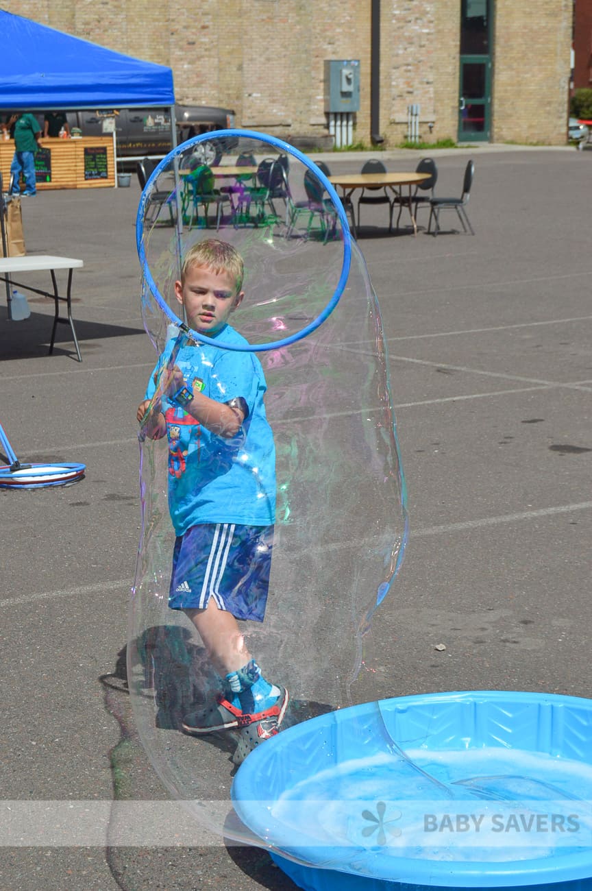 making giant bubbles with a huge bubble wand
