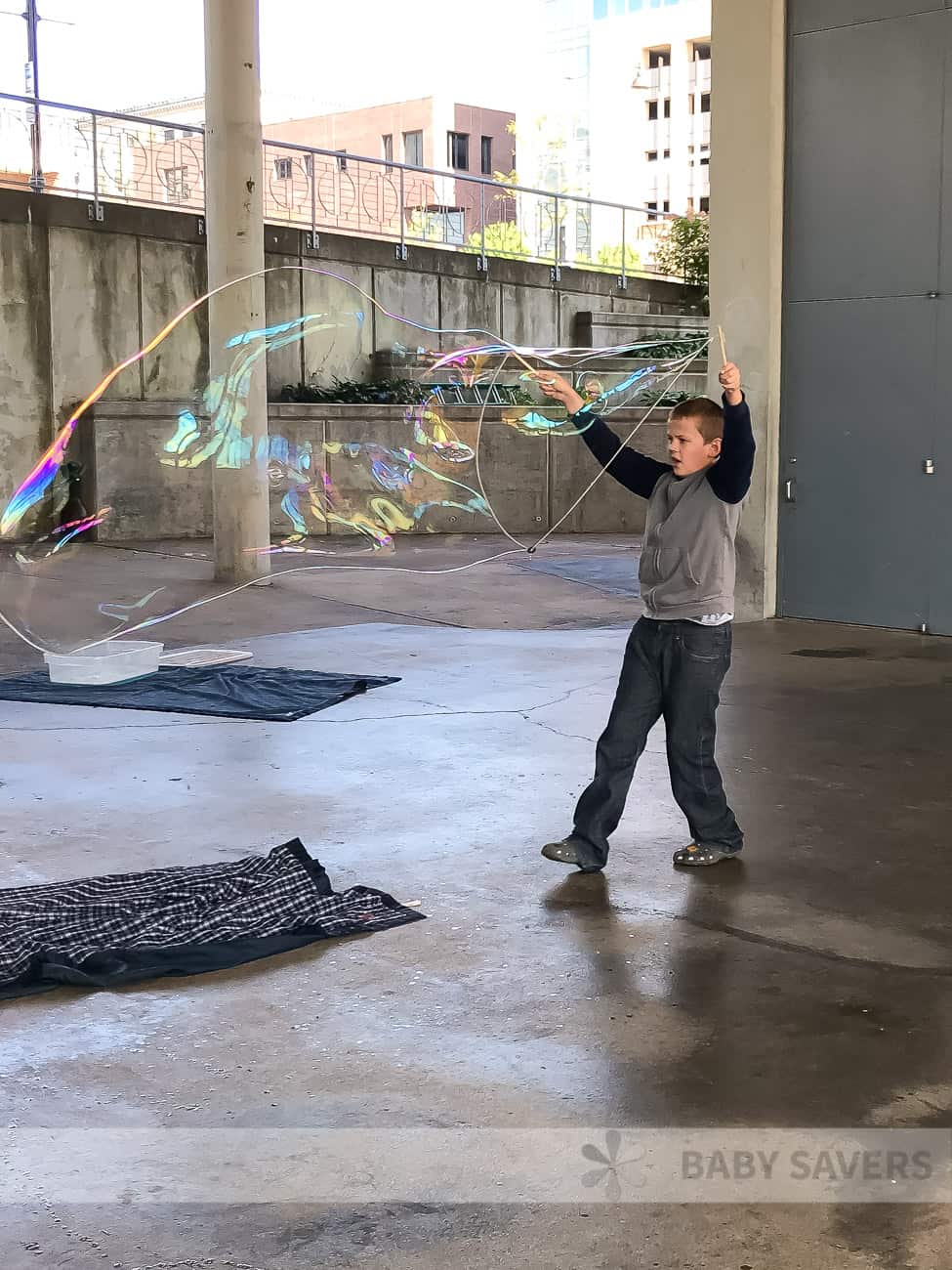 giant bubbles being made by a kid