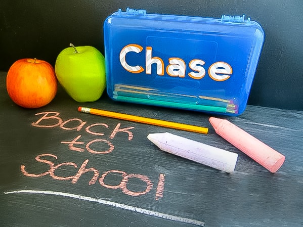 personalized pencil case on chalkboard with Back to School written on it