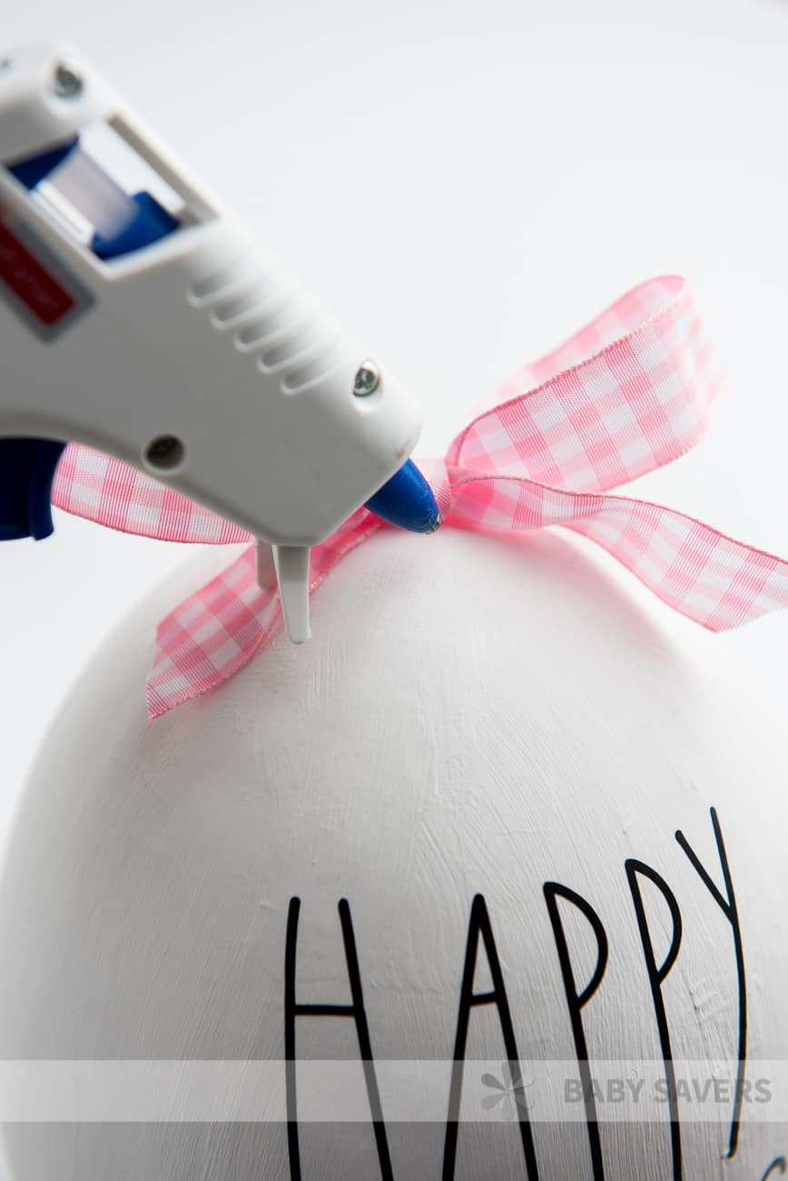 gluing ribbon onto a DIY Rae Dunn easter egg