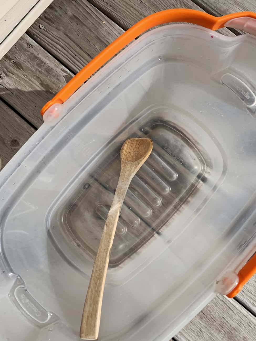 giant bubbles in bucket with wooden spoon for stirring