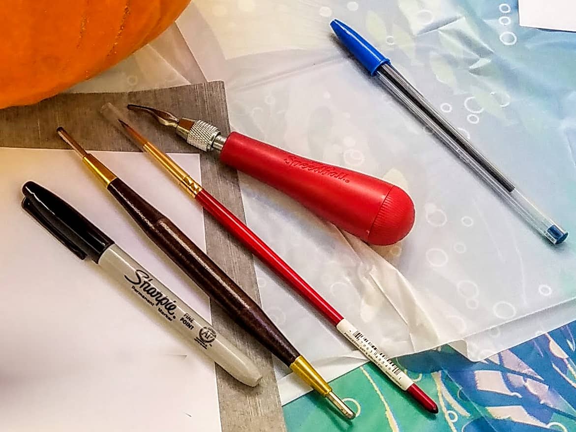 pumpkin carving tools laid out for Loki pumpkin stencils