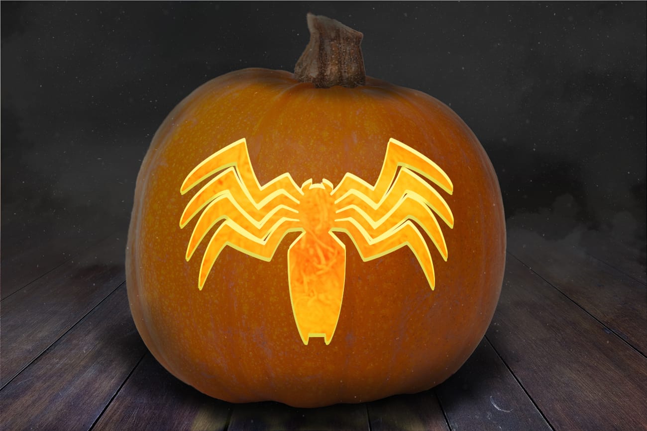 Symbol of venom pumpkin carving stencil carved into an orange pumpkin