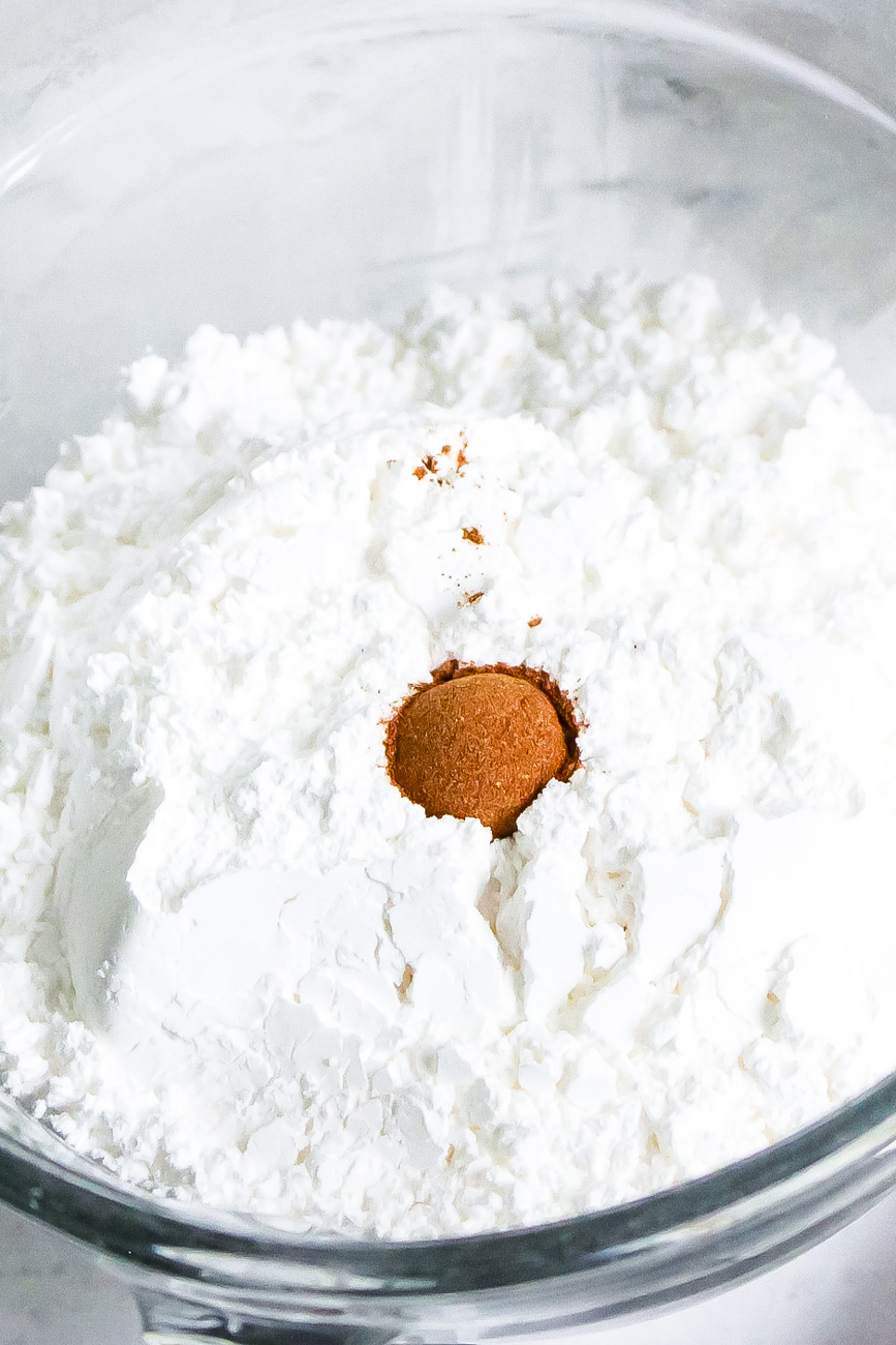 pumpkin scone recipe glaze powdered sugar and pumpkin pie spice in a bowl