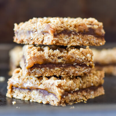 3 salted caramel bars stacked up against a dark brown background