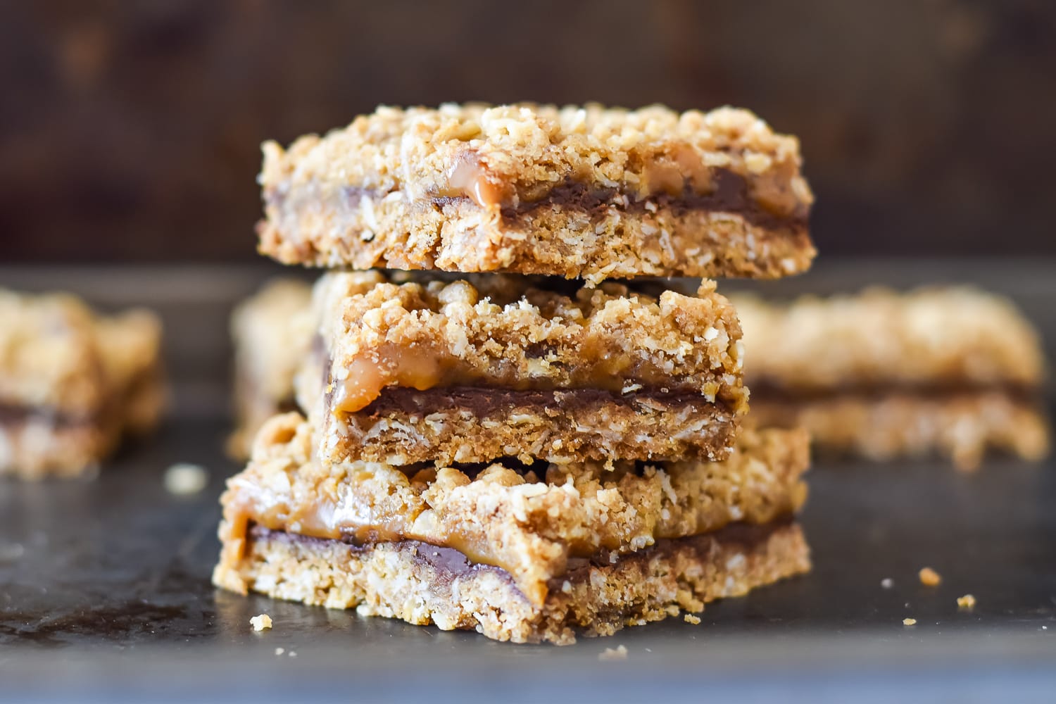 3 salted caramel bars stacked up against a dark brown background