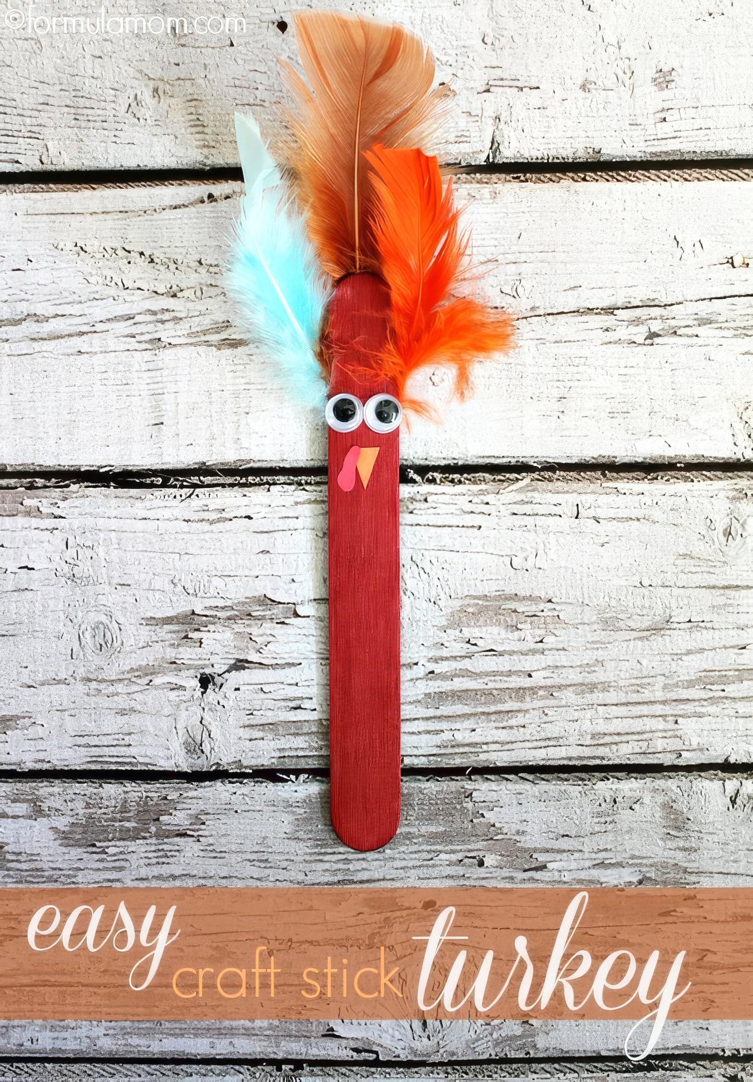 Craft stick turkey with a red painted body, googly eyes, and a beak. Feathers in orange, red, and light blue are attached to the top. The text reads "Easy Thanksgiving Crafts." The background is white distressed wood.