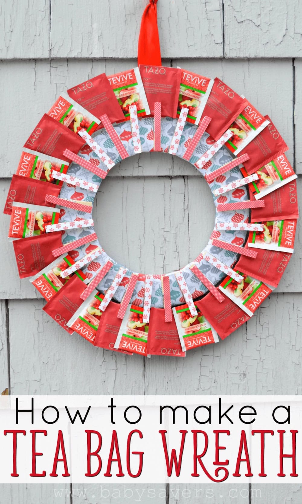 A creative tea bag wreath is made by clipping red tea bags around a circular base, then hanging it with a red ribbon on a gray shingled wall. Text below reads, "How to make a TEA BAG WREATH.
